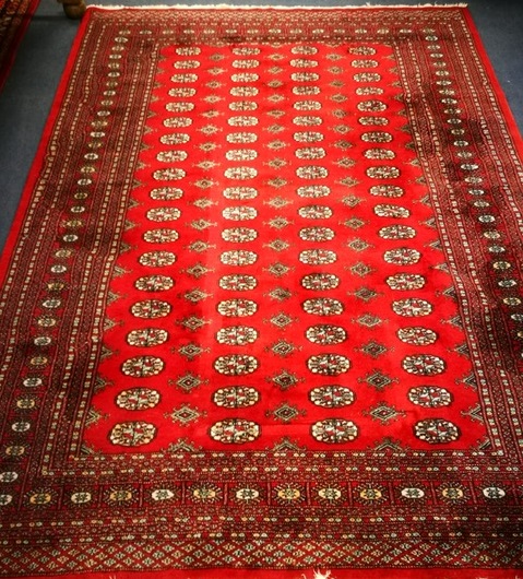 A Bokhara style red ground rug 270 x 193cm